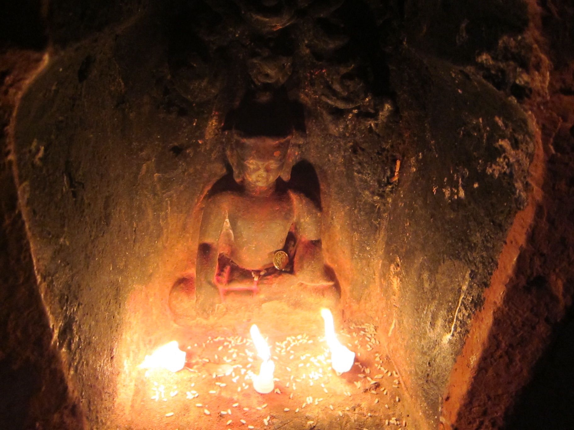 Dying candles illuminate a Buddha image at the Boudha stupa, Nepal. (Photo Ven Sarah Thresher)