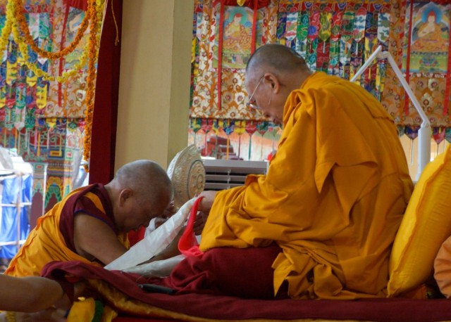 Lama Zopa Rinpoche offering Dharma wheel to His Holiness the Dalai Lama, Jangchub Lamrim teachings, India, 2014. (Photo Bill Kane)