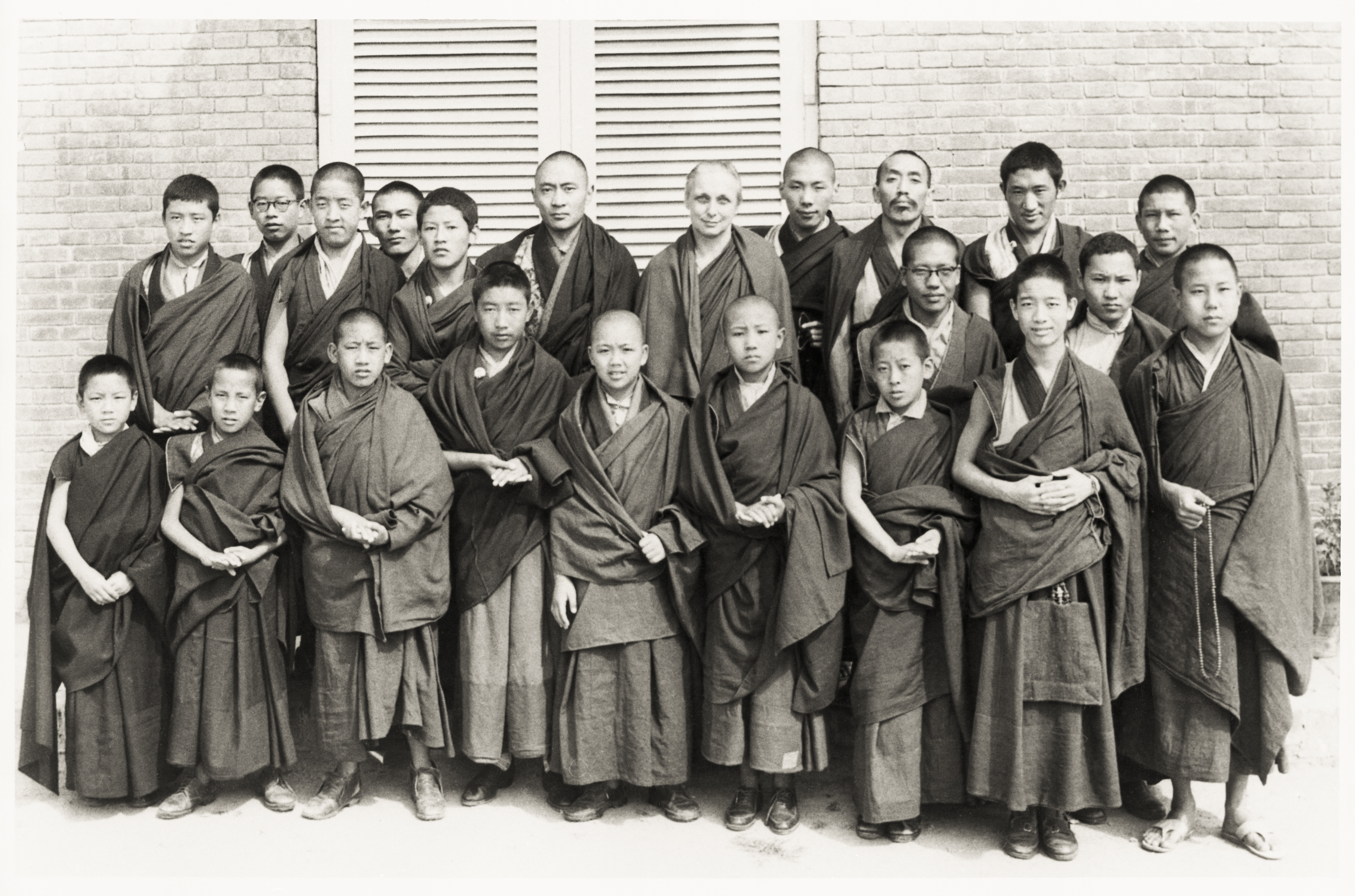 The Young Lamas School in India with Freda Bedi and Trungpa Rinpoche in the back row and a young Lama Zopa Rinpoche standing to the far left next to Thepo Tulku. Lama Zopa Rinpoche says, “That is me at school. I was older than Thepo Tulku although my body looks smaller.” (Photo Shambhala Archives Collection)