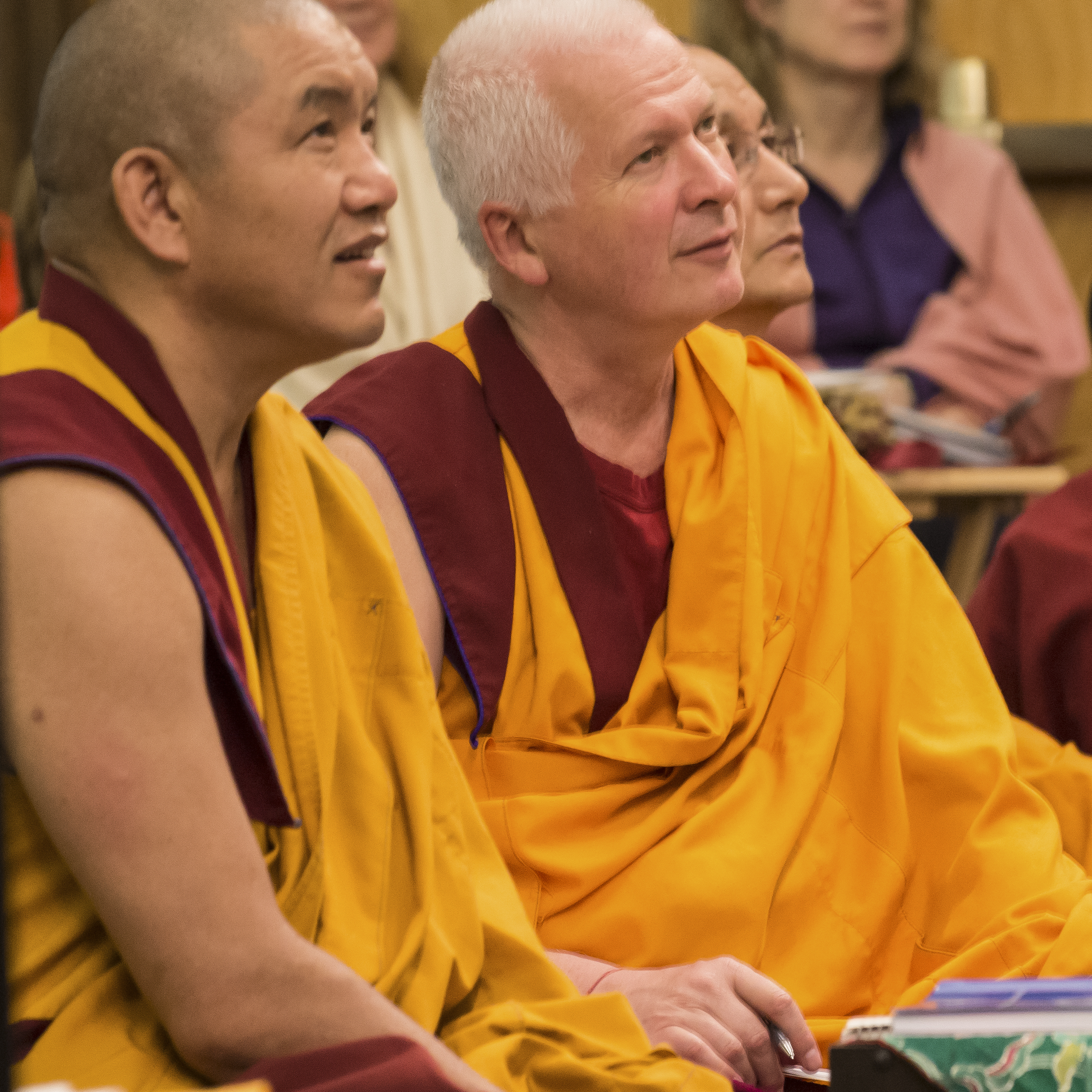 Geshe Gelek and Ven Steve watch Rinpoche teach at Light of the Path 2014. (Photo Roy Harvey)