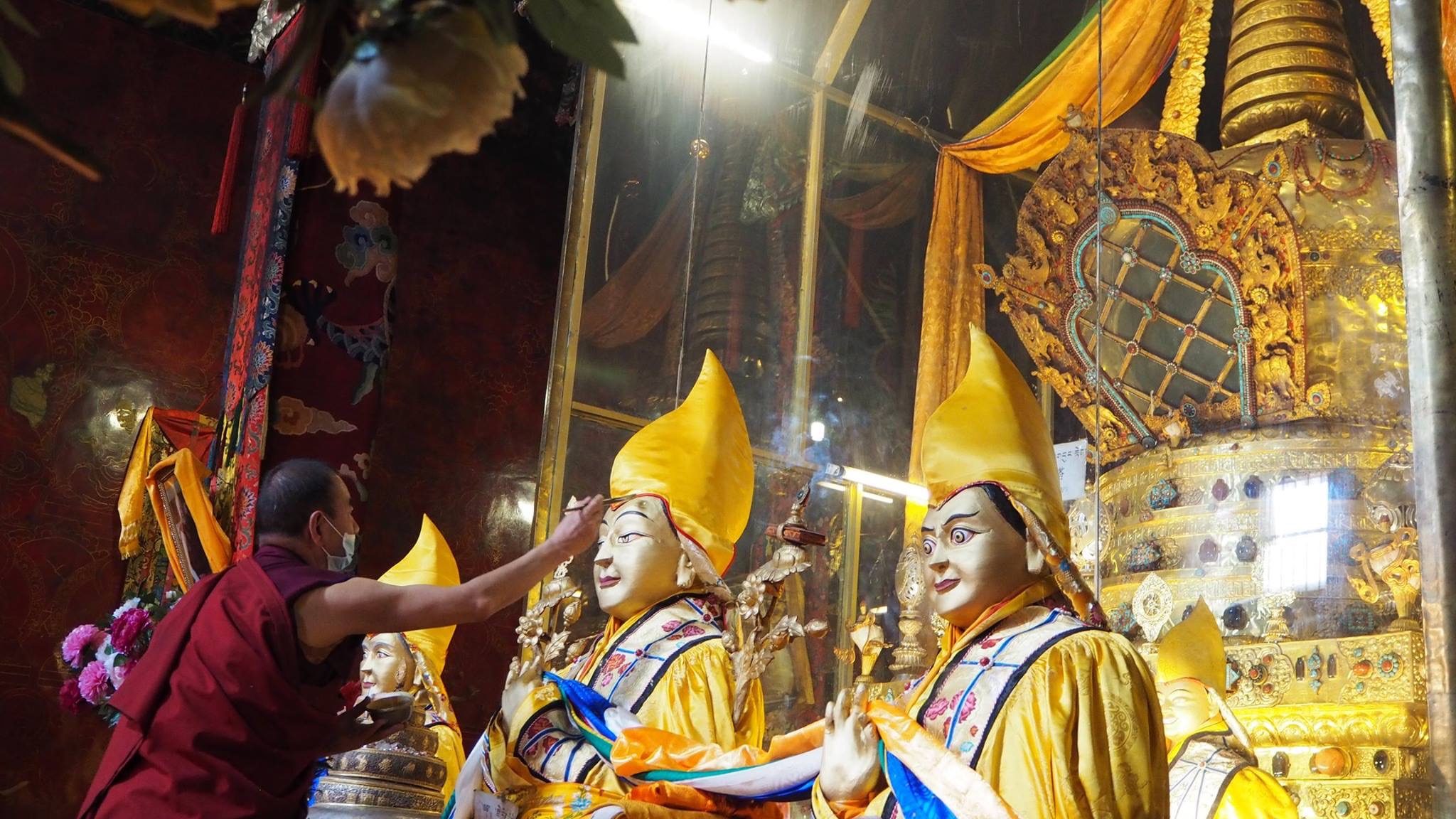 A monk applies gold to the statue of Lama Tsongkhapa in front of the stupa of his relics at Ganden Monastery, Tibet. (Photo Ven Tenzin Tsultrim)