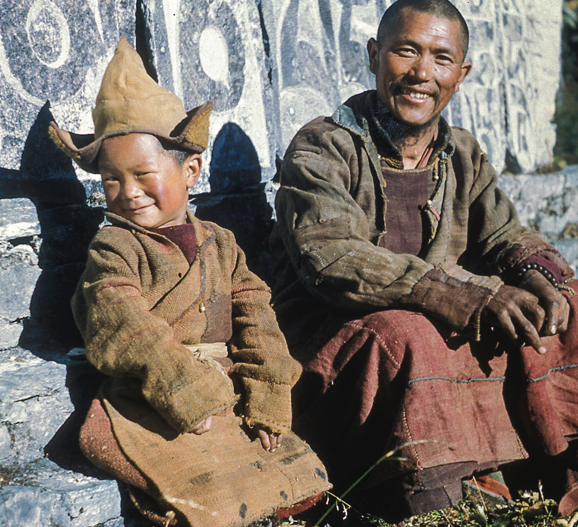 A young Lama Zopa Rinpoche in Solu Khumbu sitting next to his first teacher, Aku Lekshe, who taught Rinpoche the alphabet. (Photo Thomas Weir)