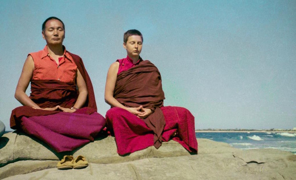 Lama and Yeshe Khadro meditating by the ocean in Australia, 1974. (Photographer unknown)