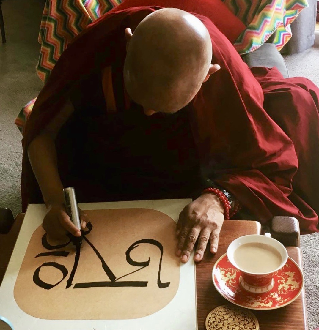Lama Zopa Rinpoche drawing the syllable AH, 2018. (Photo Ven Roger Kunsang)